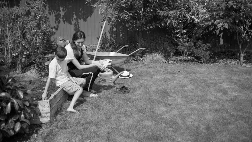 Woman gardening with her son