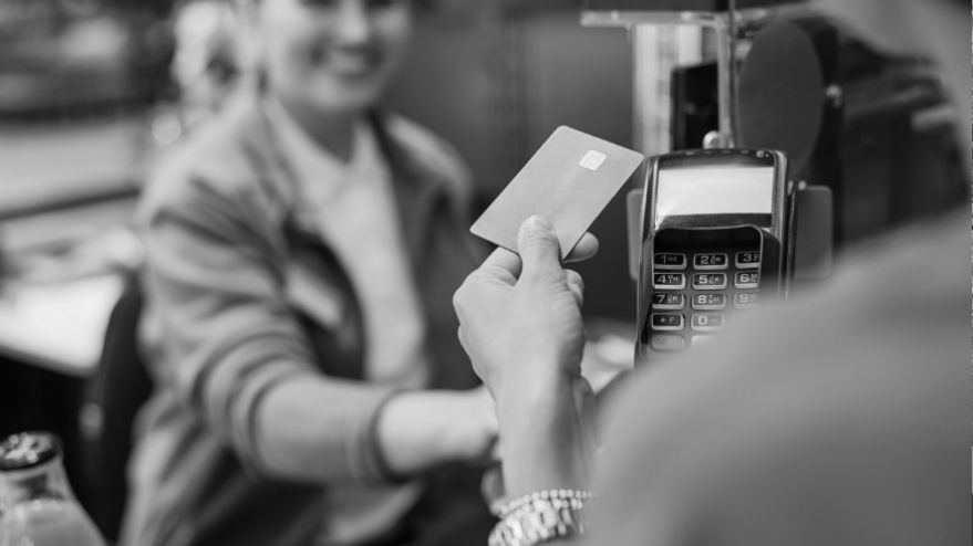 Image of a person paying with their credit card