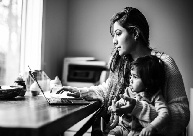 Young mother applying for a refinance loan on a laptop