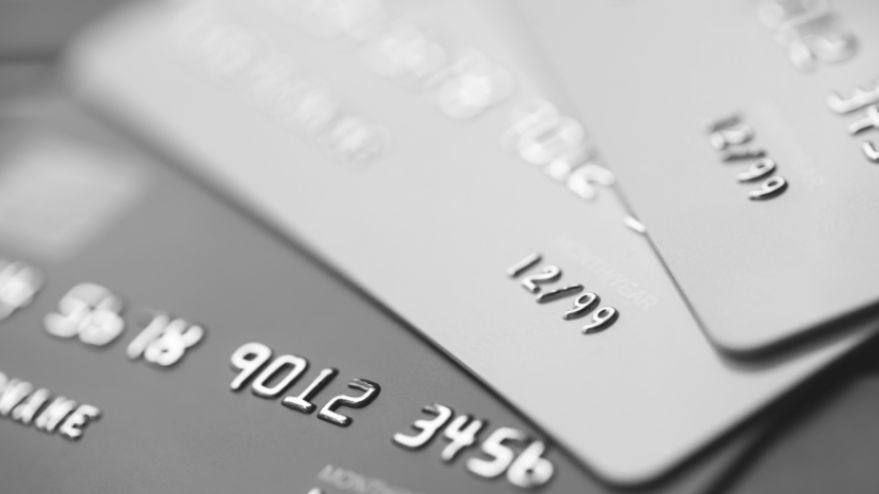 Three credit cards set up in a line
