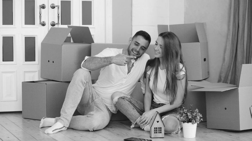 First time home buyers smiling with house keys in their hands
