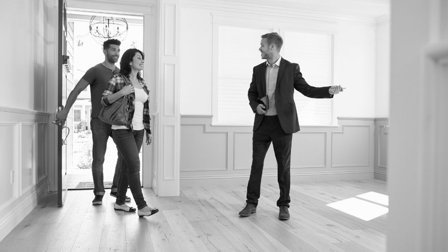 Couple being shown a house by an estate agent