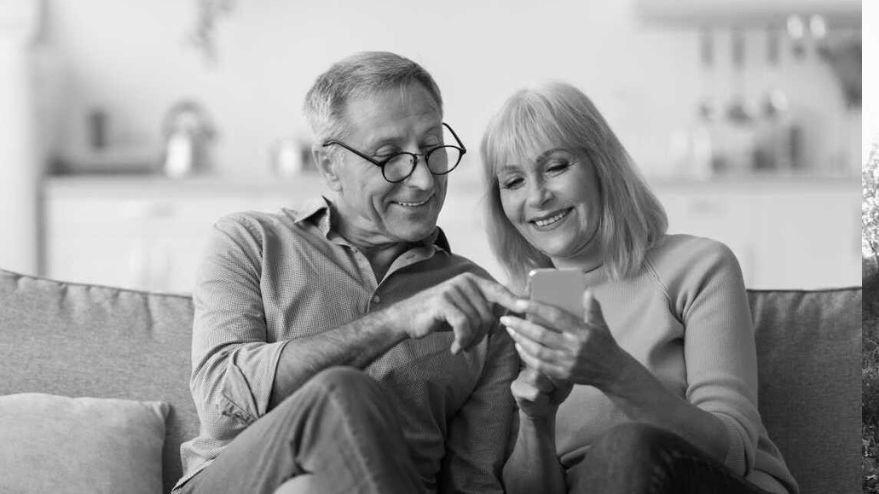 elderly couple looking at their phone