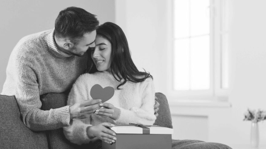 Image of a couple together holding a love heart together on Valentines Day